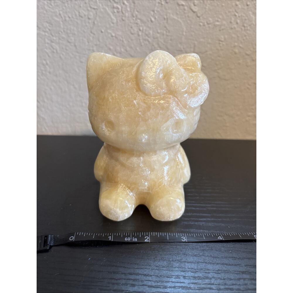Large Hello Kitty carving made of yellow or orange calcite
